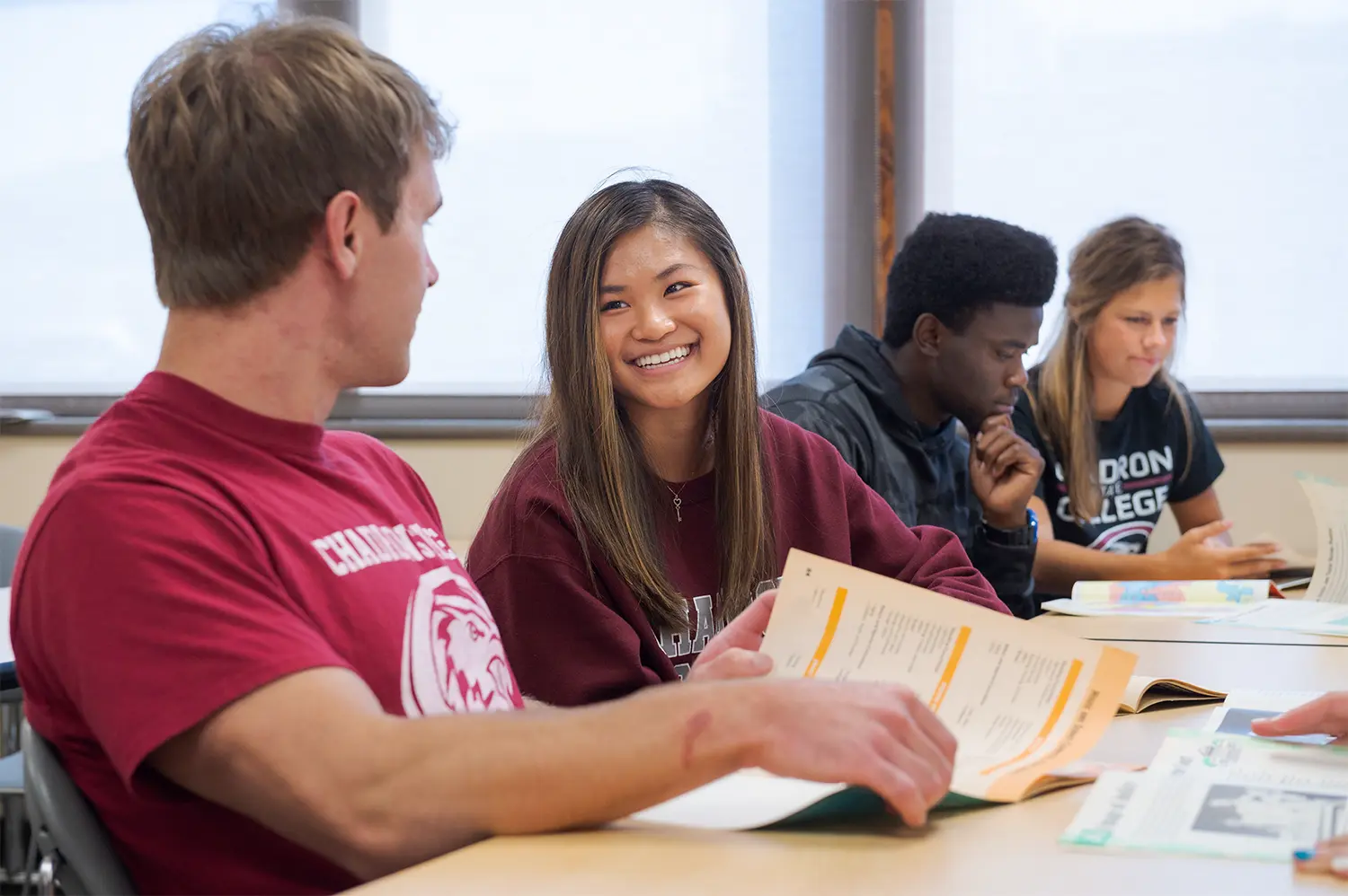 Several students laugh during a classroom discussion