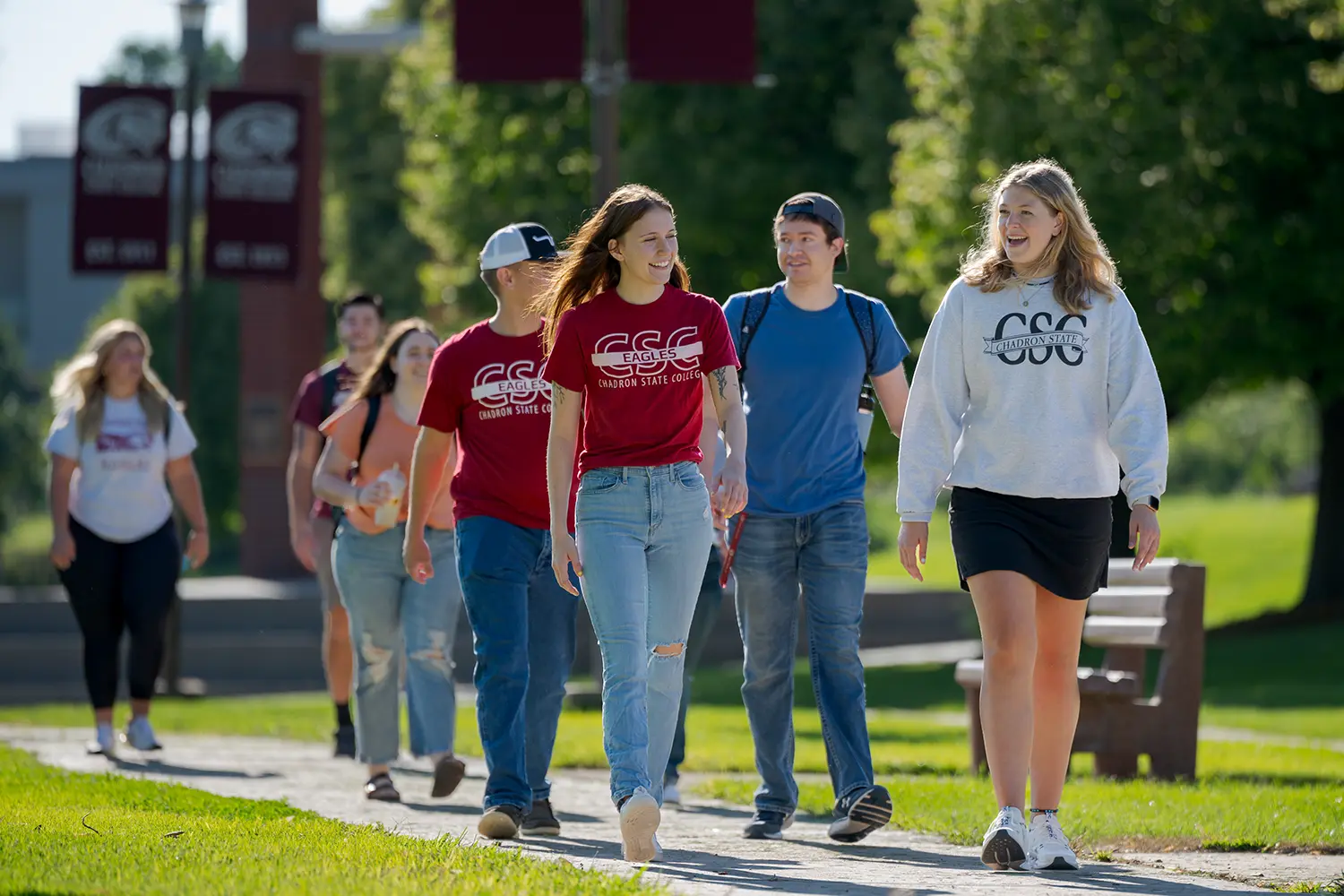 A group of students walks down the main thoroughfare