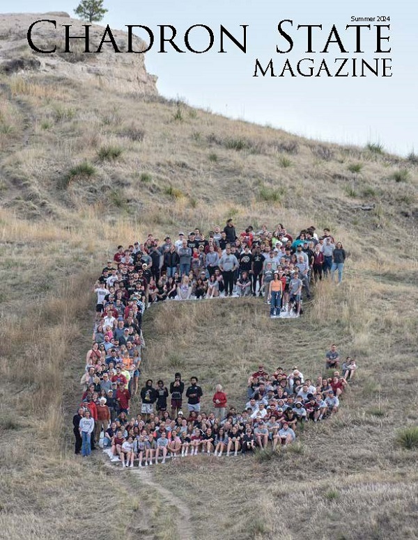 Cover of the summer 2024 Chadron State Magazine, image shows peopl standing on the C on C-Hill