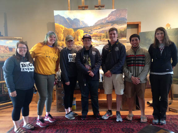 A group of students pose in an art gallery