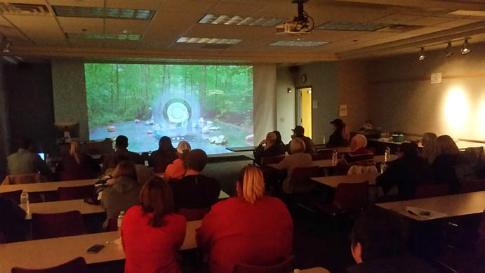 Students watch a video in a Memorial Hall classroom