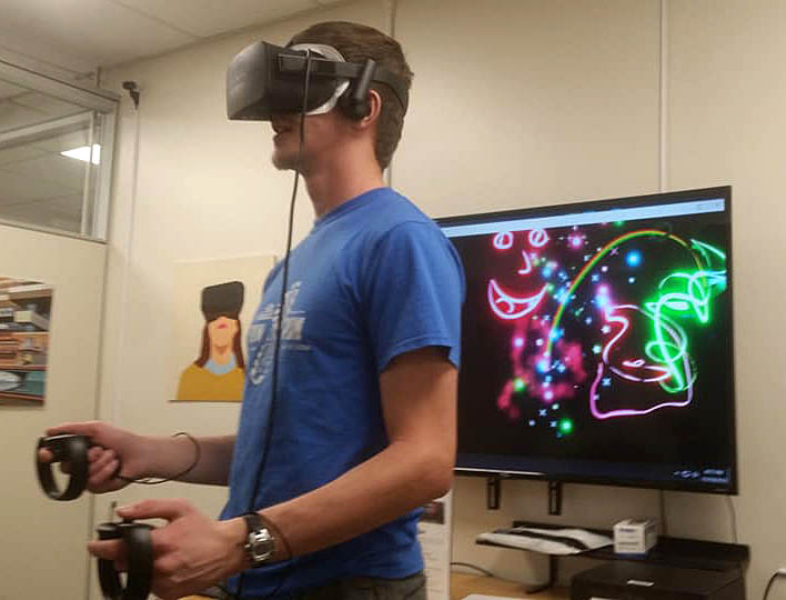 A student works on art using virtual reality equipment