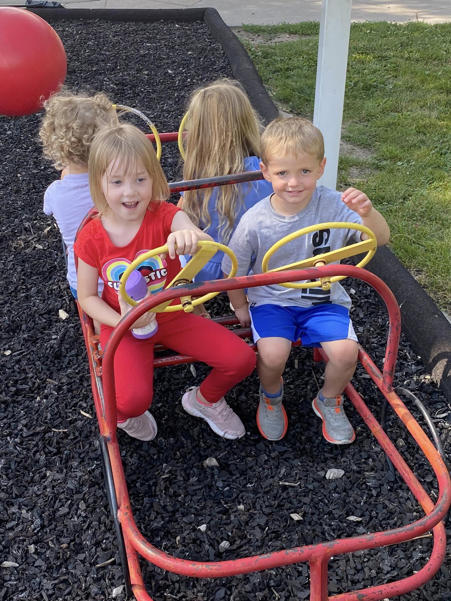 A group of children play outside the Child Development Center