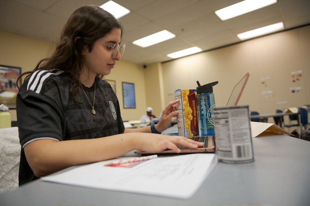 A student examines nutrition information in the Burkhiser Complex
