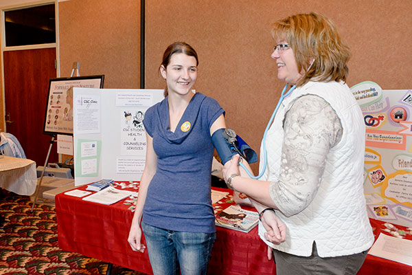 A nurse takes a student's blood pressure