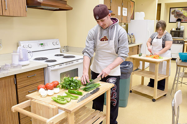 Students prepare food in the kitchen at the Burkhiser Technology Complex