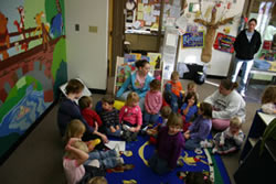 A group of children sit for an activity at the Child Development Center Laboratory