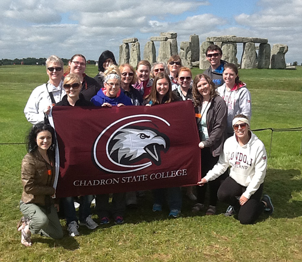 Group holding CSC flag at stonehenge