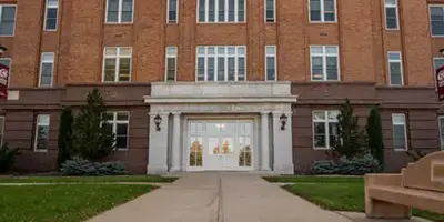 A close up of the doors of the old administration building on campus