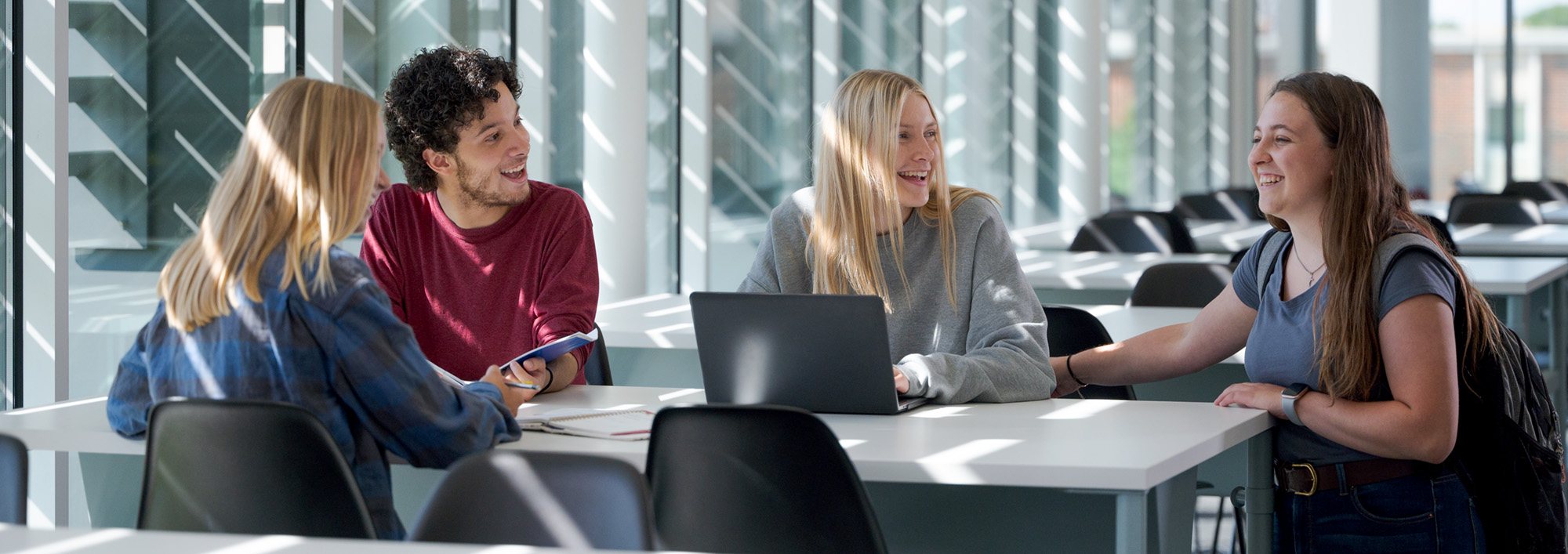 Four students relax at a table in the Math Science Center of Innovative Learning