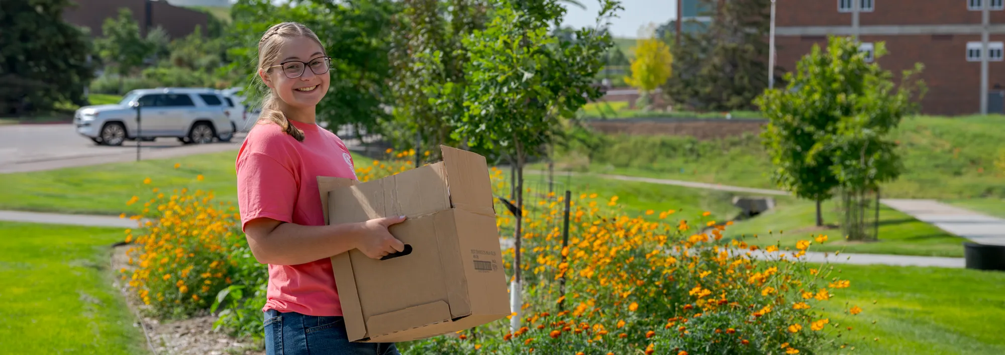 A student carrying a box during campus move-in