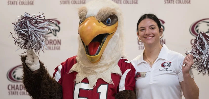 Eagle mascot and student posing for a photo