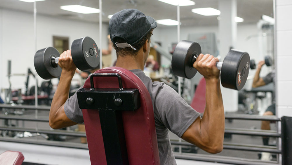 A student lifts weights
