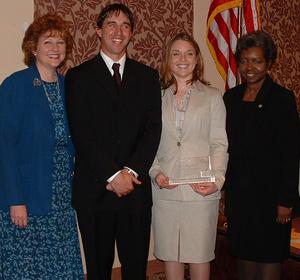 Chadron State students Eric Stewart of McCook and Jennifer Koza of Chadron display the award while flanked by Nebraska First Lady Stephanie Johanns and Jamesena Moore, Nebraska Volunteer Service Commission chairwoman.