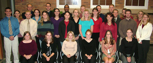 Students in Delta Mu Delta pose for a photo