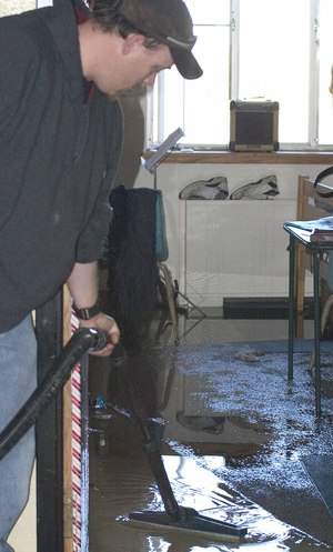 Man cleans water up in a dorm