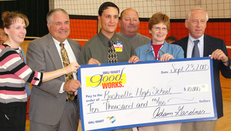 Sherry Retzlaff poses with his award and check.