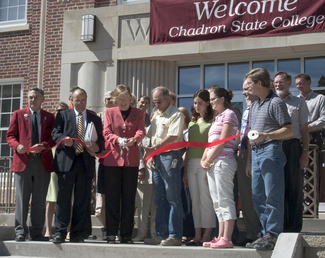 President Dr. Janie Park is joined by by college students, members of the Dawes County Chamber of Commerce, architects, college employees and contractors Friday as she cuts the ribbon.