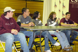 Health professions students sit at a table in Armstrong gym.