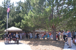 Attendees of Saturday's dedication ceremony listen while Jo Streumpler, wife of the late Art Struempler, speaks at Chadron State College's new flag plaza which bears her husband's name.