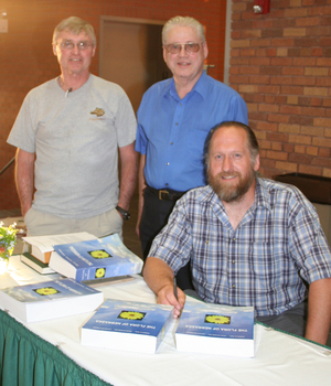 Writers of the book pose for a picture at the book signing.