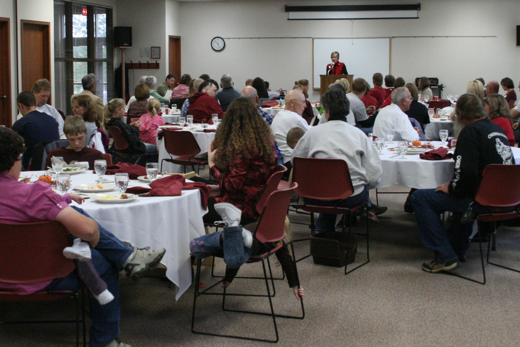 Janie Park speaks to tables of families