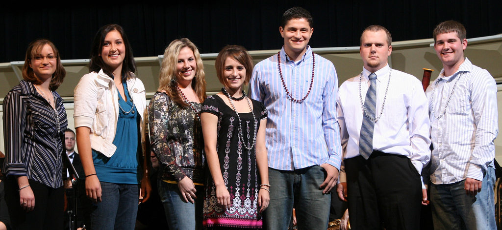Students pose on stage