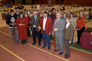 People pose to do a ribbon cutting