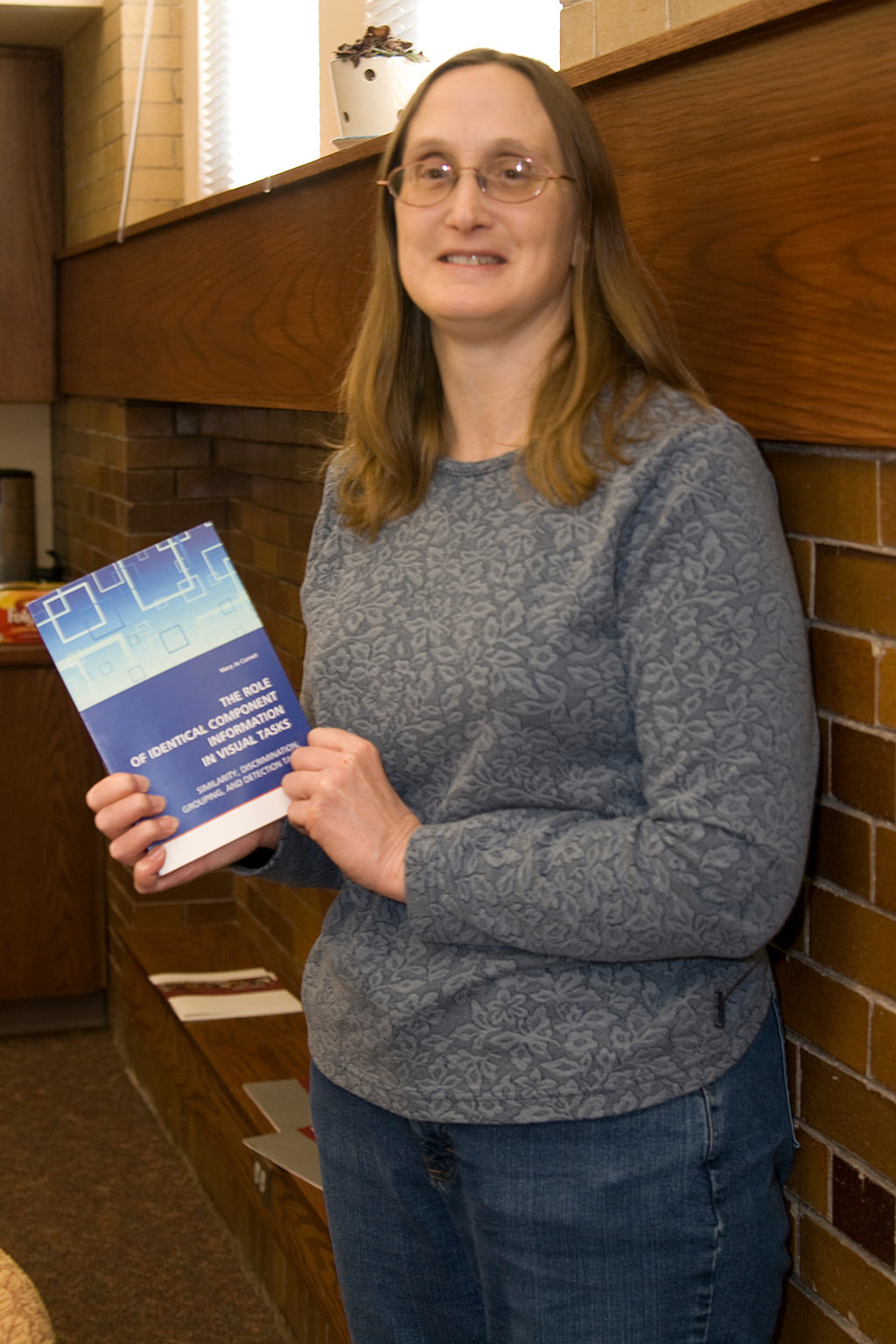 Mary Jo Carnot displays the book that was recently published,
