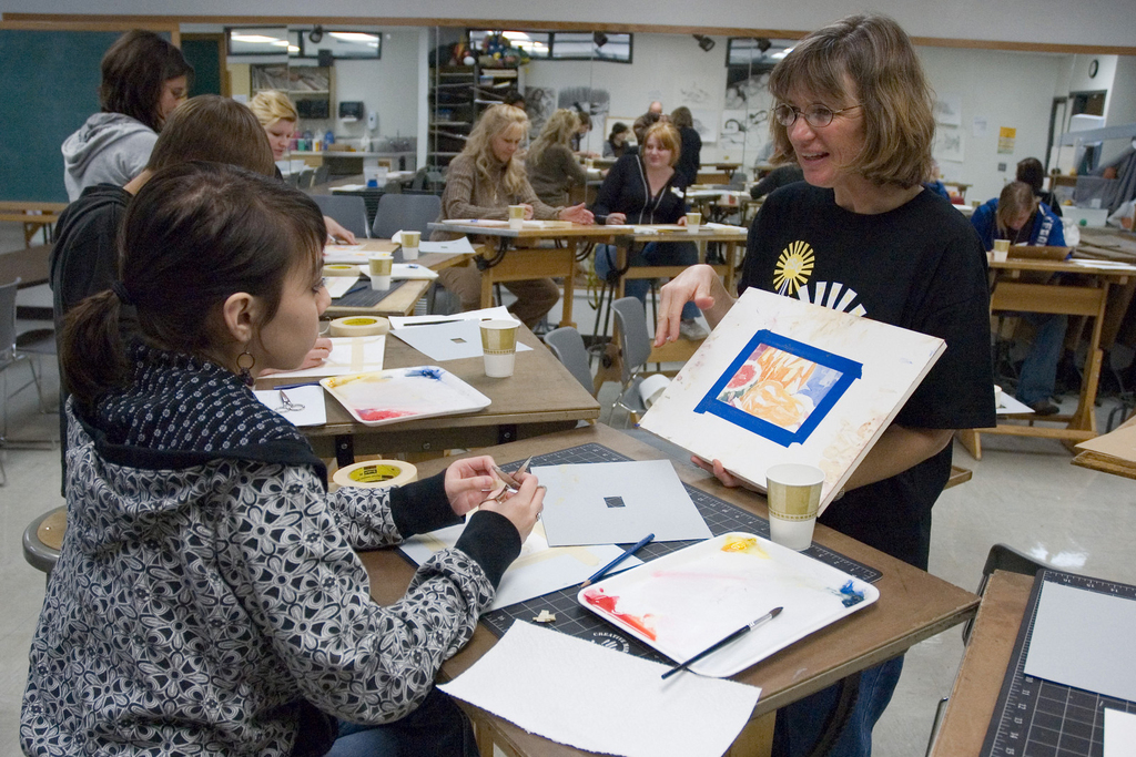 Chadron State College adjunct faculty member Nancy Sharps works with regional high school students on watercolor paintings.