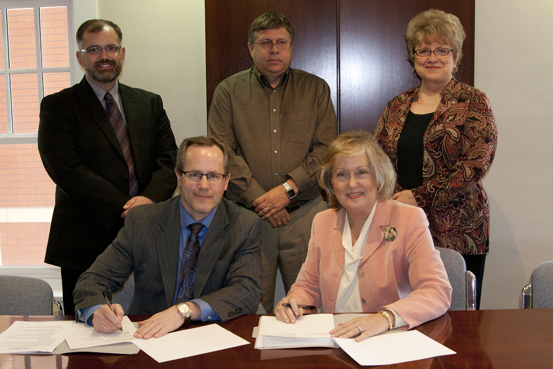 Presidents Todd Holcomb, Western Nebraska Community College, and Janie Park, Chadron State College, sign the new memorandums of understanding.