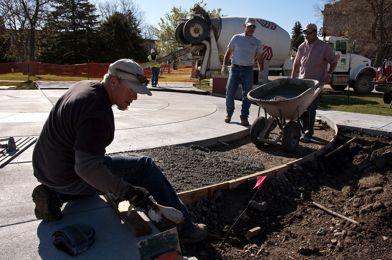Workers pour concrete for the new flag plaza on the Dean's Green on May 10.