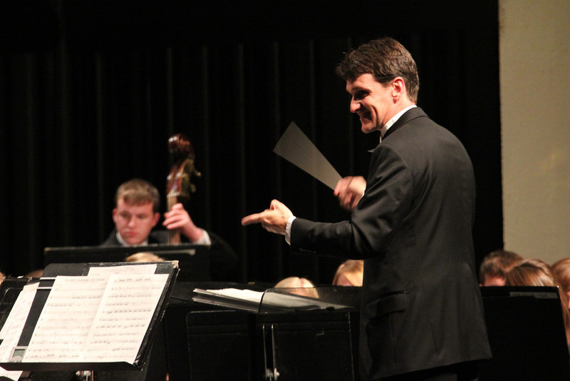 Dr. Adam Lambert directs the Wind Symphony during a March performance. (Photo by Justin Haag)