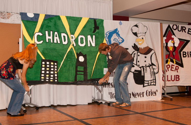 Ashley Riesen and Adam Neumann, 2011 Chadron State College homecoming queen and king, help unveil the winners of the bed sheet decorating contest. The annual contest is one of the many fun events occurring for homecoming this week. (Photo by Justin Haag)