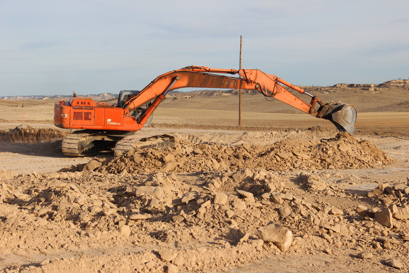 A track hoe moves dirt for the construction of the Rangeland Complex on Dec. 5. (Photo by Justin Haag)