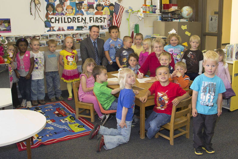 Children of the Chadron State College Child Development Center and Dean Joel Hyer join Chadron Mayor Karin Fischer as she proclaims April 22-28 Week of the Young Child in Chadron.