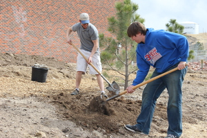 Clayton Osborn and Conner Bila shovel outside of Burkhiser