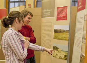 Two people observe the display