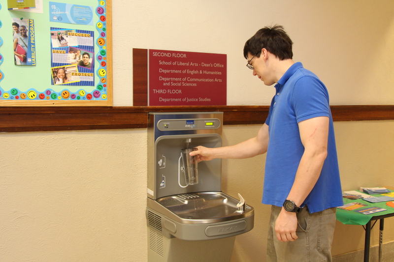 Graduate student Frank Bright uses the first water bottle filling station installed on campus.