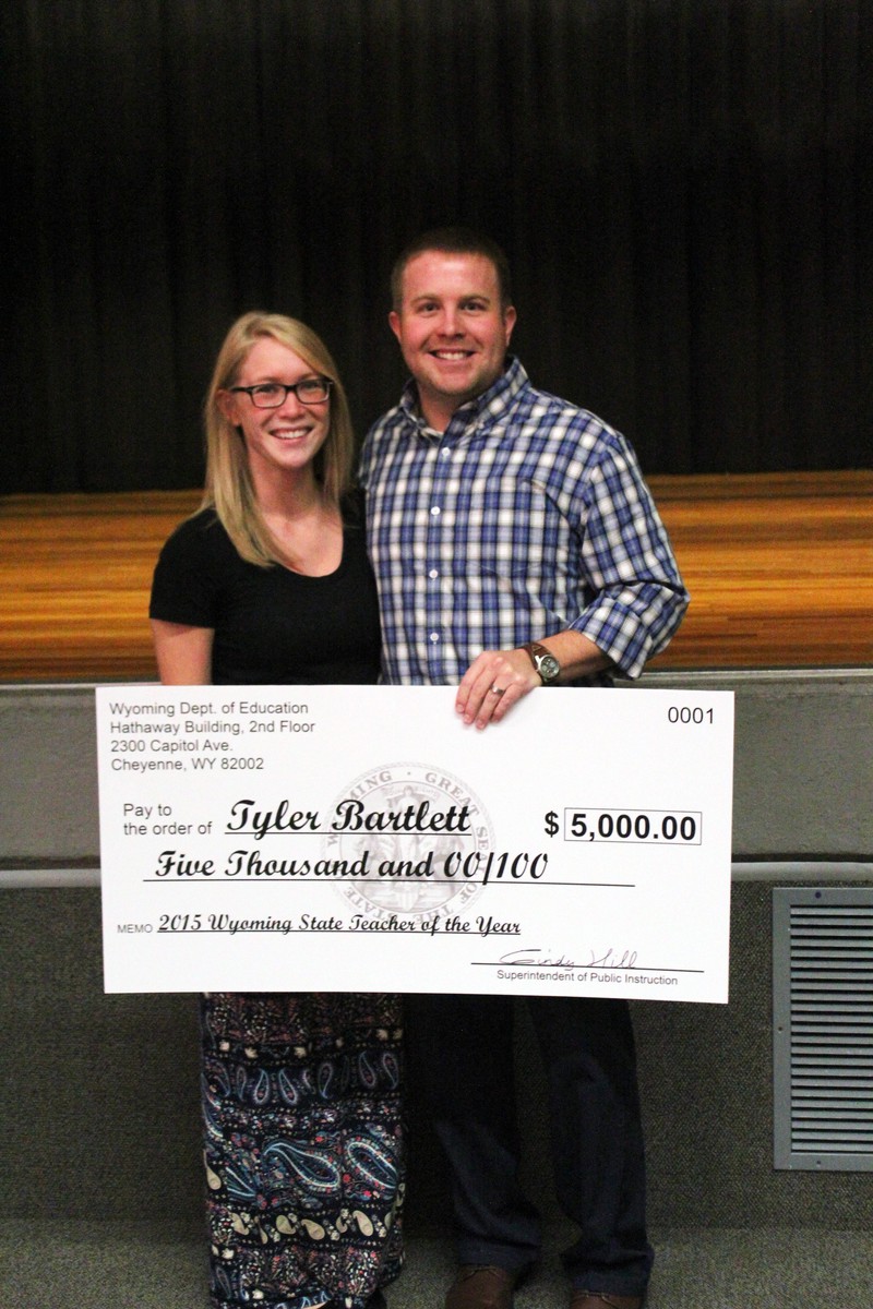 Tyler Bartlett, right, with his wife, Nikki Bartlett, also a CSC graduate, after he received the 2015 Teacher of the Year award from Wyoming State Superintendent of Public Instruction Cindy Hill. (Photo courtesy News Letter Journal)