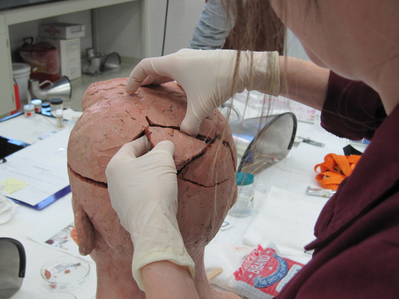 A technician at a firm in Omaha works to repair a bust by the late William Artis, former Chadron State College art faculty member. (Courtesy photo)