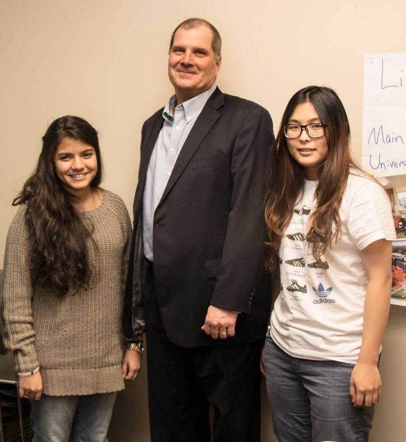 BridgePathways graduates Dec. 11 in Old Admin with the Chadron State College president. From left, Lina Garatly of Jeddah, Saudia Arabia, Dr. Randy Rhine and Ting Qian of Shanghai, China. (Tena L. Cook/Chadron State College)