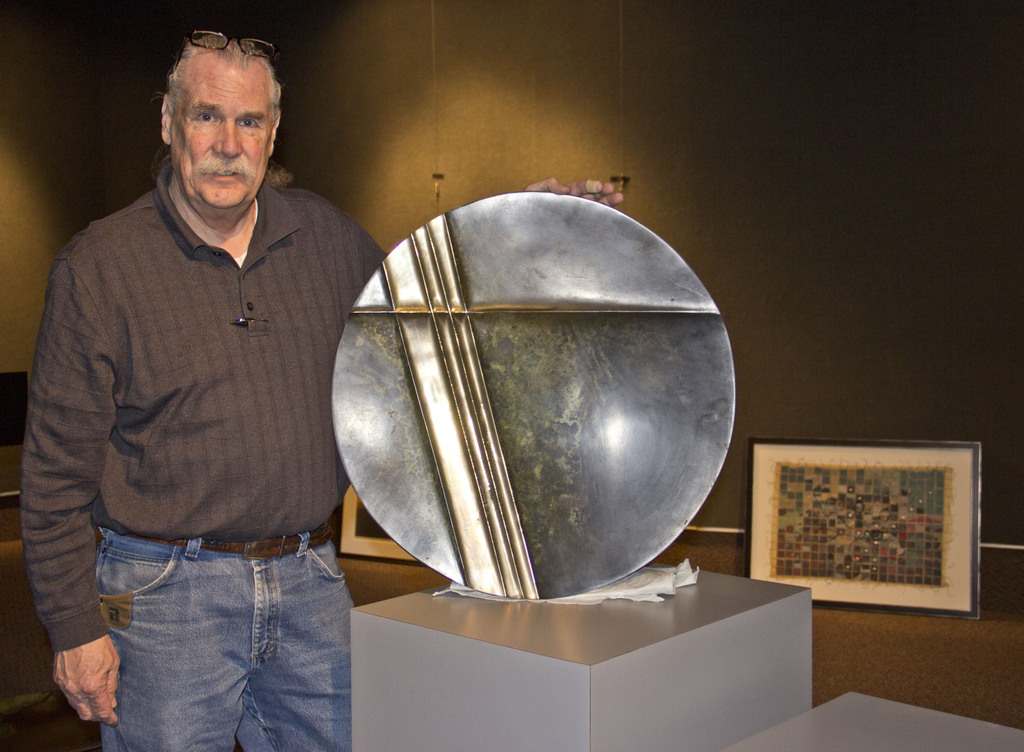 Dirk Bird with one of the bronze platters included in his show March 17-April 4 in the Memorial Hall Main Gallery.
