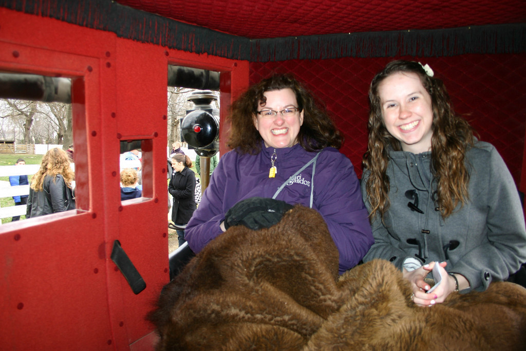 From left, Sarah Polak and CSC student Emily Sample prepare for a stagecoach ride complete with a buffalo robe at the Mahaffie Stagecoach Stop and Farm in Olathe, Kan.