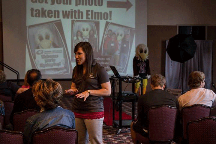 Caitlin Spencer, START advisor, speaks with families gathered for an earlier Chadron State College Signing Day.