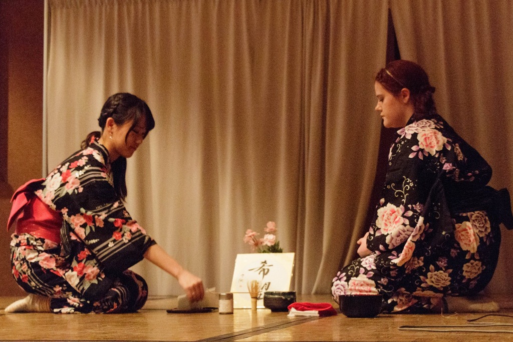 A tea ceremony is performed by Chadron State College students, from left, Yurika Koga of Yokohama, Japan, and Analise Garland of Wall, South Dakota, during the 2014 International Club Tasting Dinner.