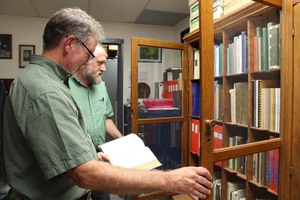 Jim Locklear, left, director of conservation at the Lauritzen Gardens in Omaha, Nebraska, visits the Claude Barr Memorial Collection in the High Plains Herbarium at Chadron State College. Steve Rolfsmeier, right, herbarium director, assists Locklear with his research. (Tena L. Cook/Chadron State College)