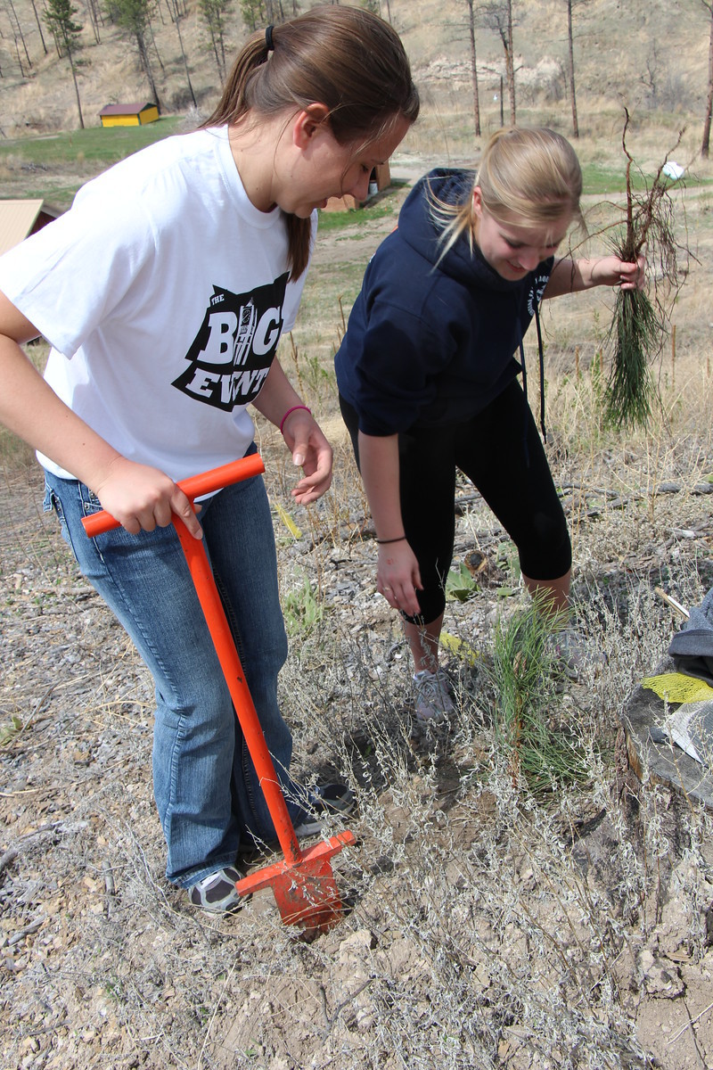 The Big Event volunteers Diane Baluska of Kimball and Chelsea Owe plant a tree.