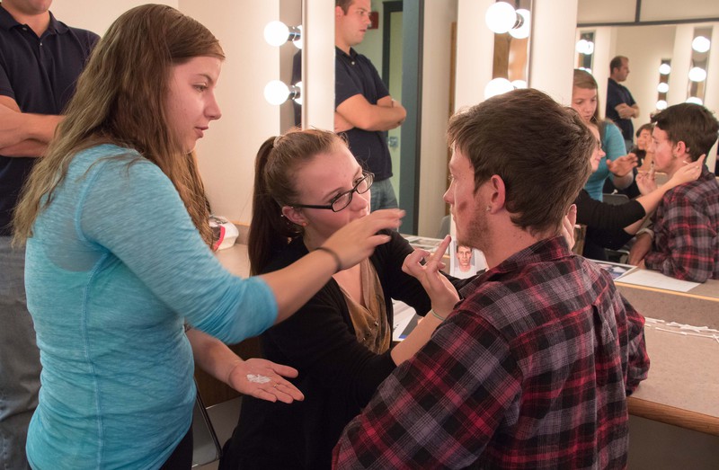 Tasha Holtz teaches Taylor Kelsch how to create aging lines and bruises with makeup