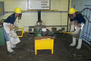 Phil Colella and Rod Clause pour aluminum into a sculpture mold